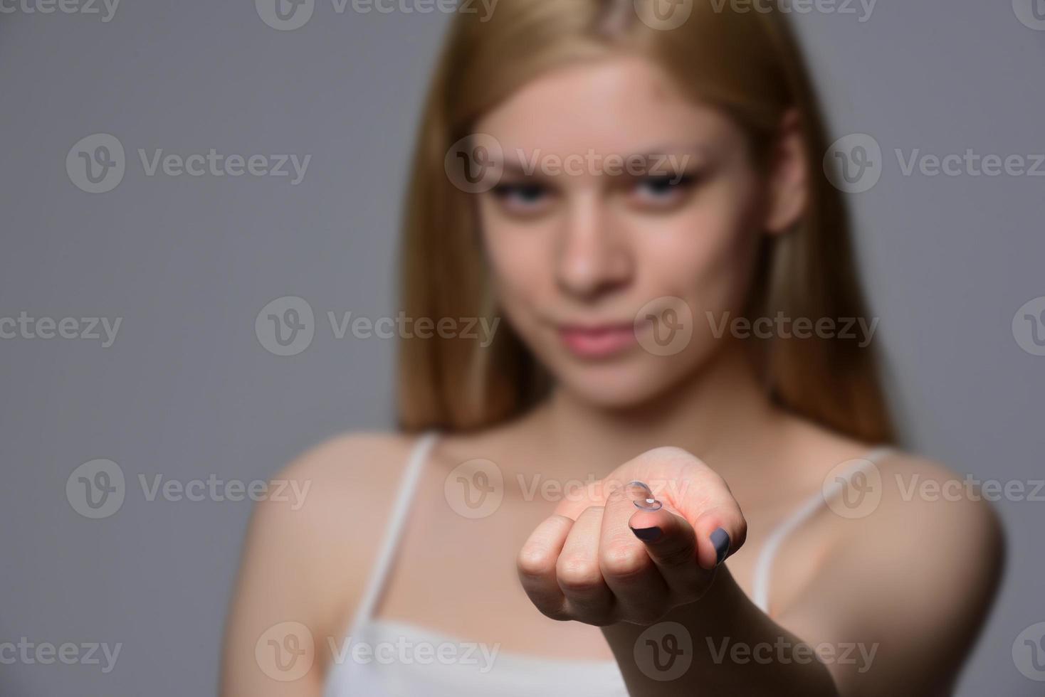 Contact Lens For Vision. Closeup Of Female Face With Applying Contact Lens On Her Brown Eyes. Beautiful Woman Putting Eye Lenses With Hands. Ophthalmology Medicine And Health. High Resolution photo