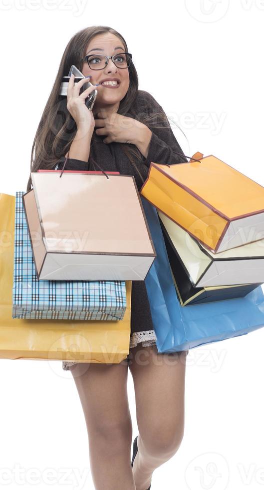 Happy woman with shopping bag on isolated studio background. photo