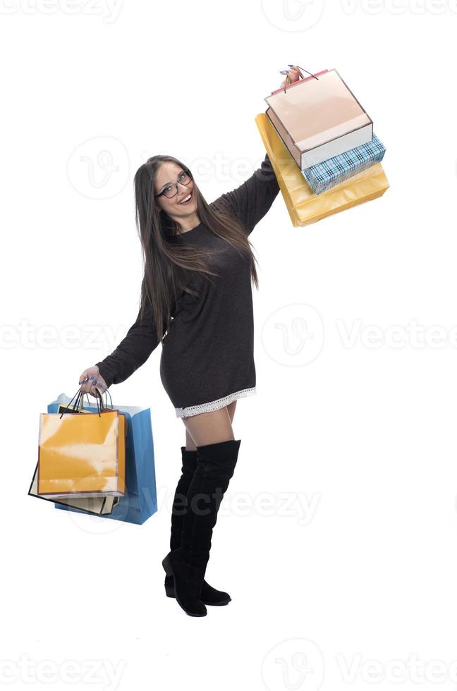 Happy woman full body portrait with shopping bag on isolated studio background. photo