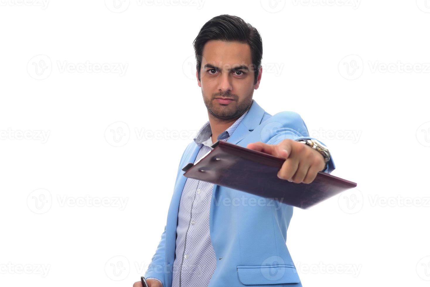 Arab businessman holding paperwork on clipboard and pointing with his finger. isolated on white photo