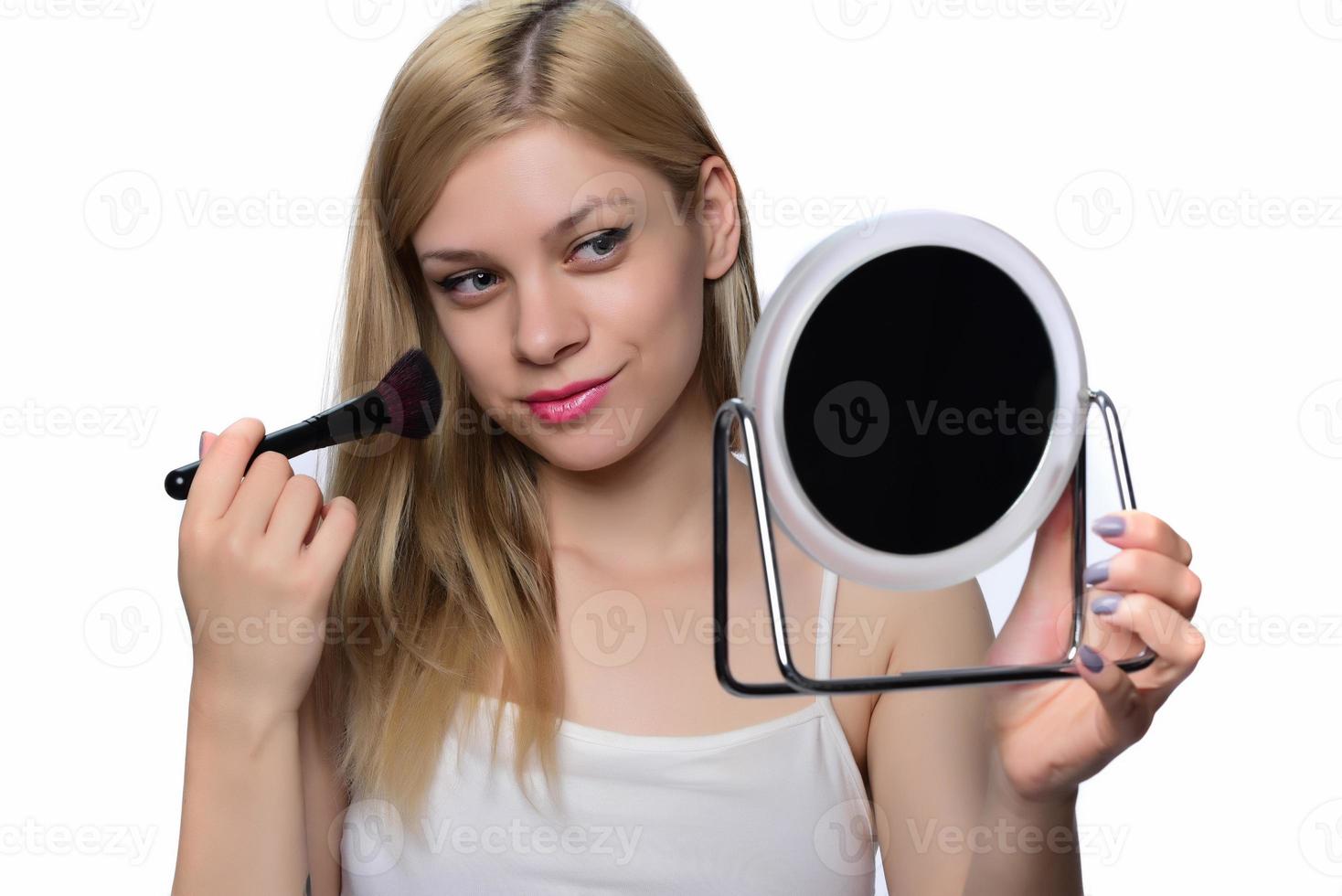 Young woman doing makeup. photo
