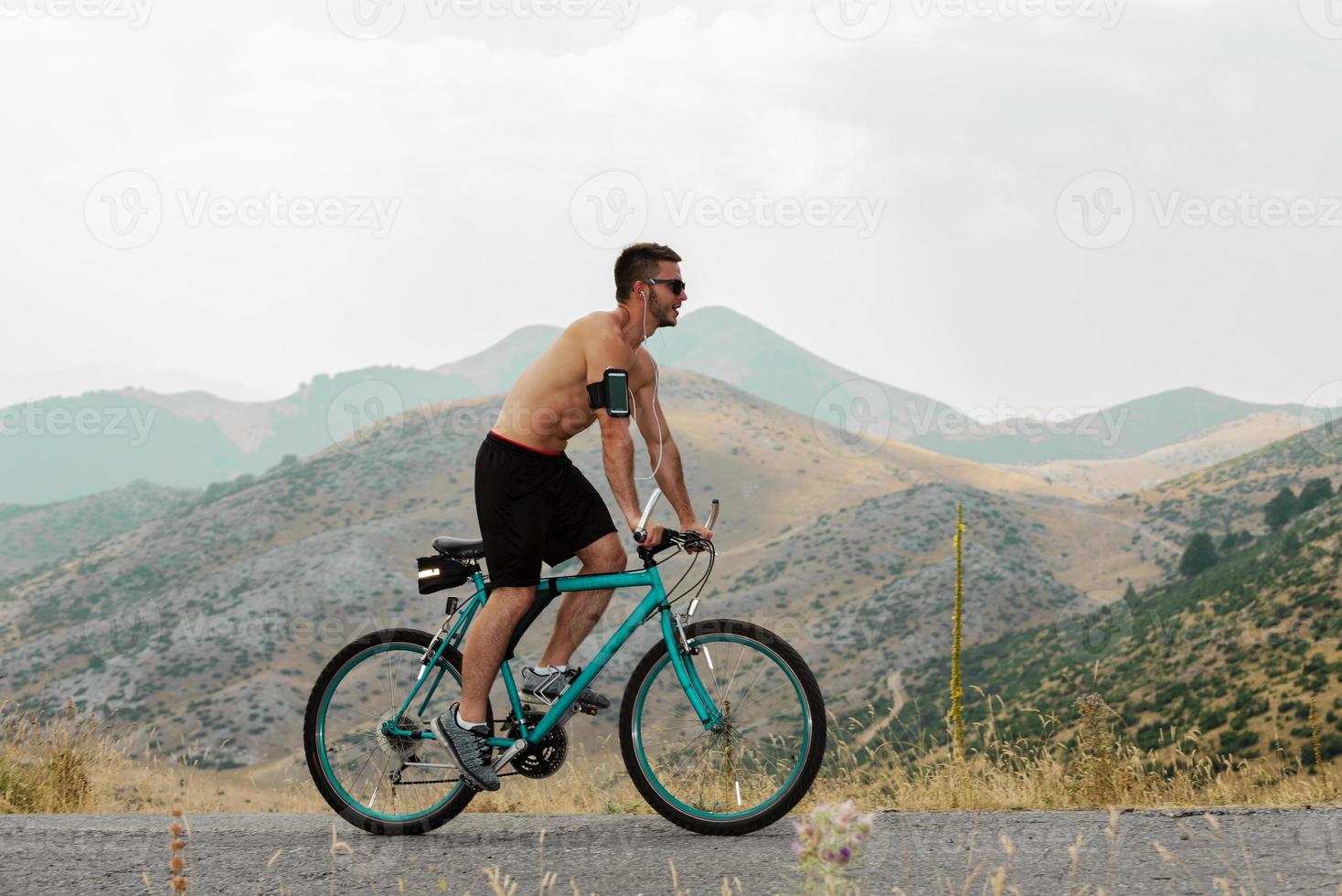 Mountain biking MTB cyclist man cycling on bike trail on coast at sunset photo