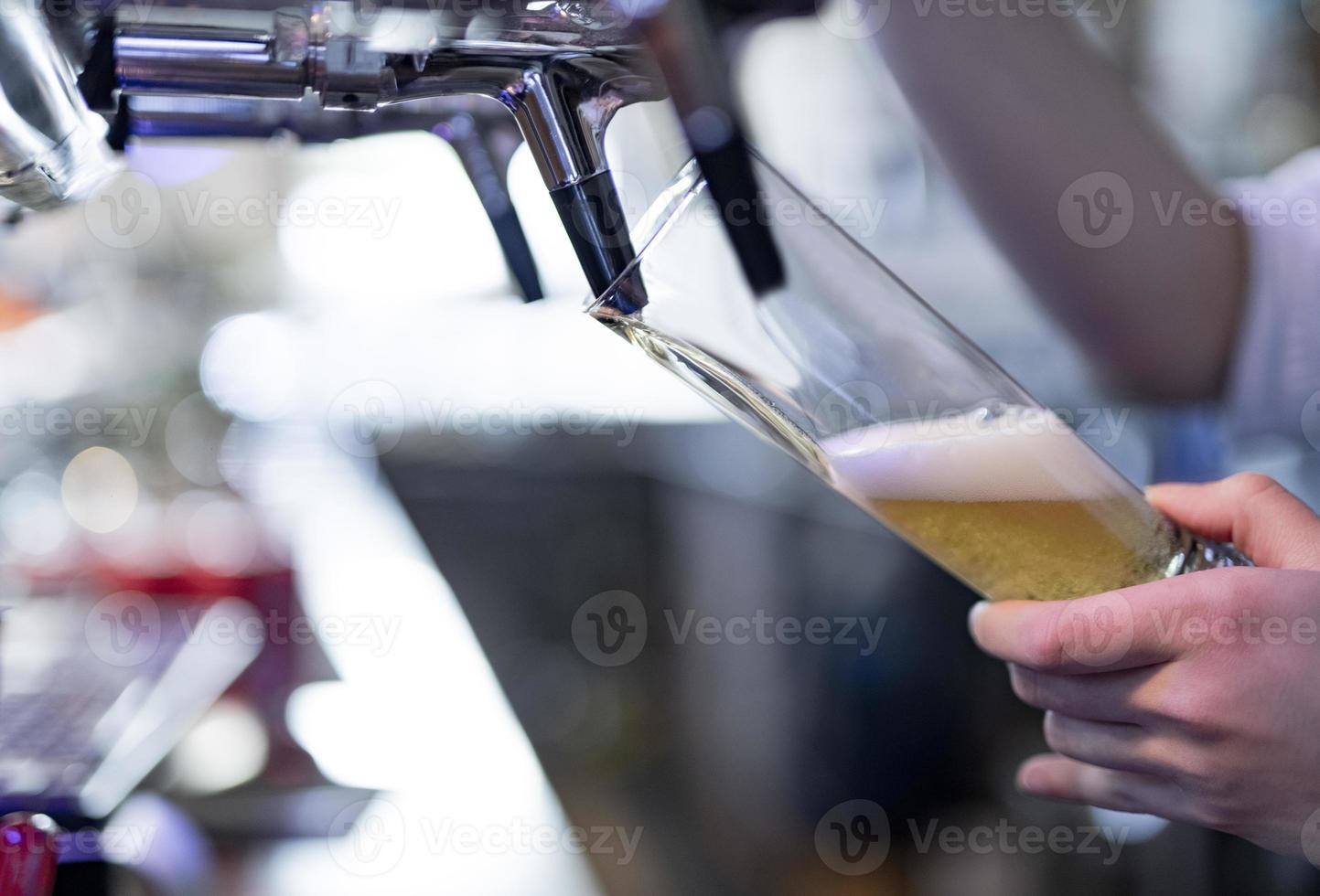 pouring a lager beer in a glass. photo