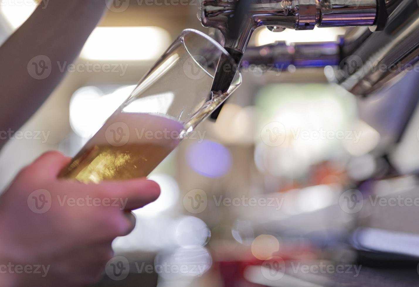 pouring a lager beer in a glass. photo