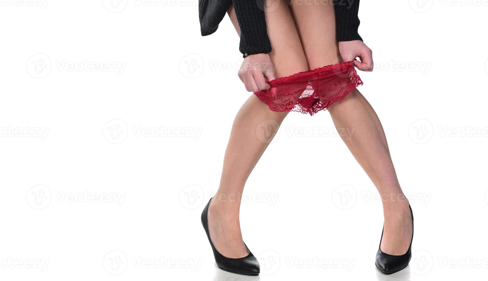 A picture of a sexy woman putting on panties over white background photo