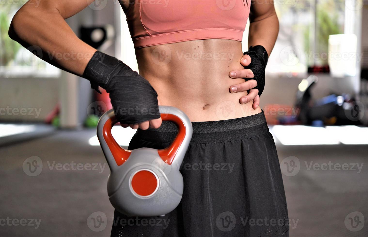 women exercise with kettle bells in a gym. concept about fitness, sport and people. selective focus photo
