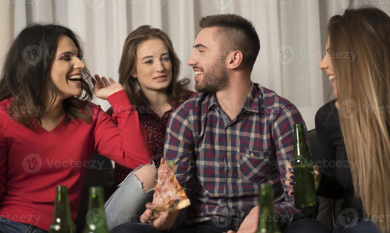 Gathering of multiracial young best friends having a fun party indoors photo