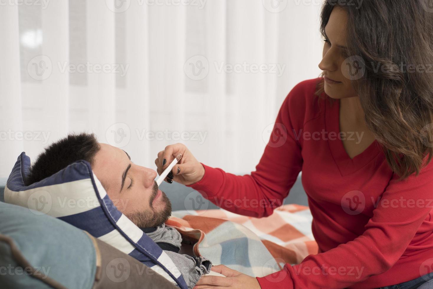 young Woman comforting her ill husband photo