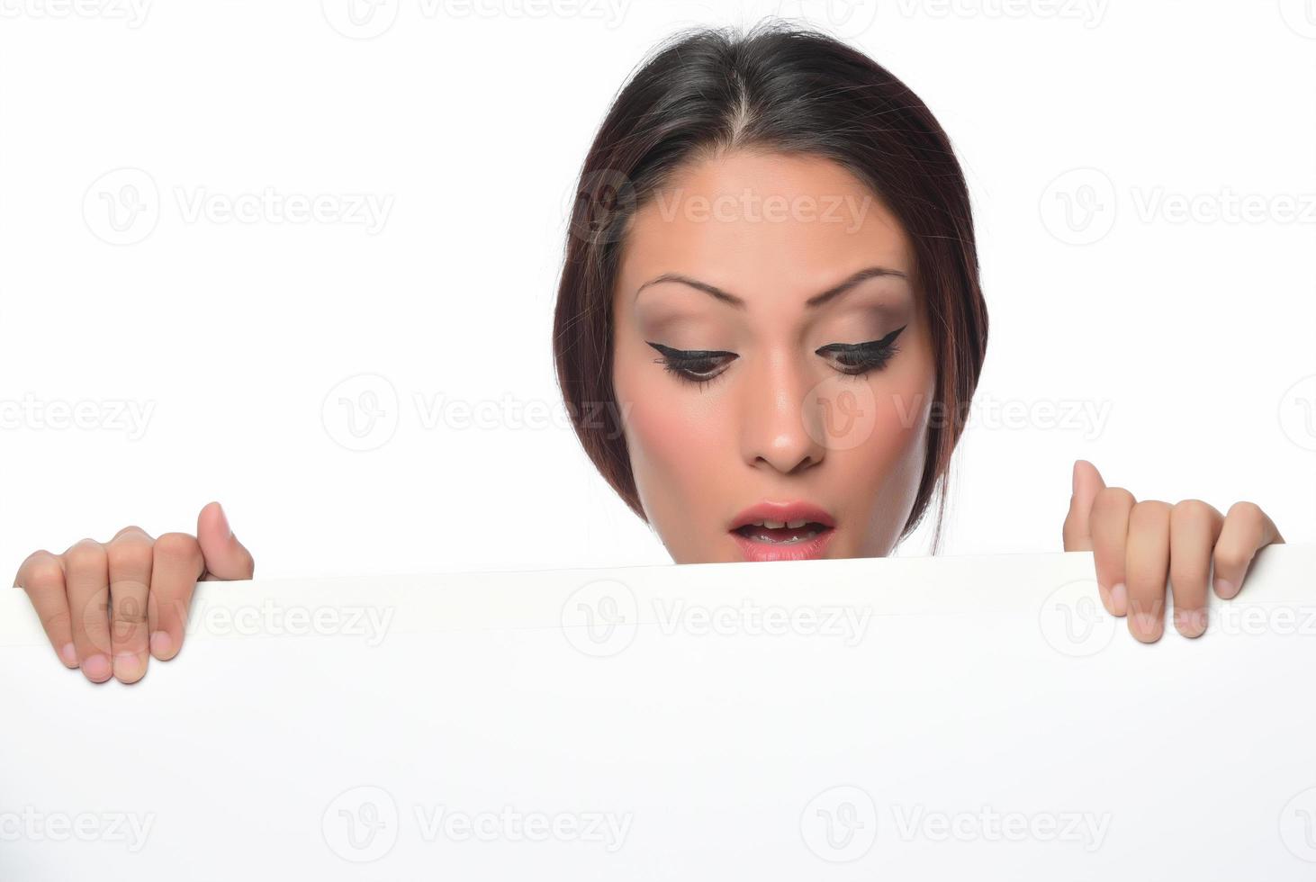 young smiling woman holding a blank sheet of paper for advertising photo