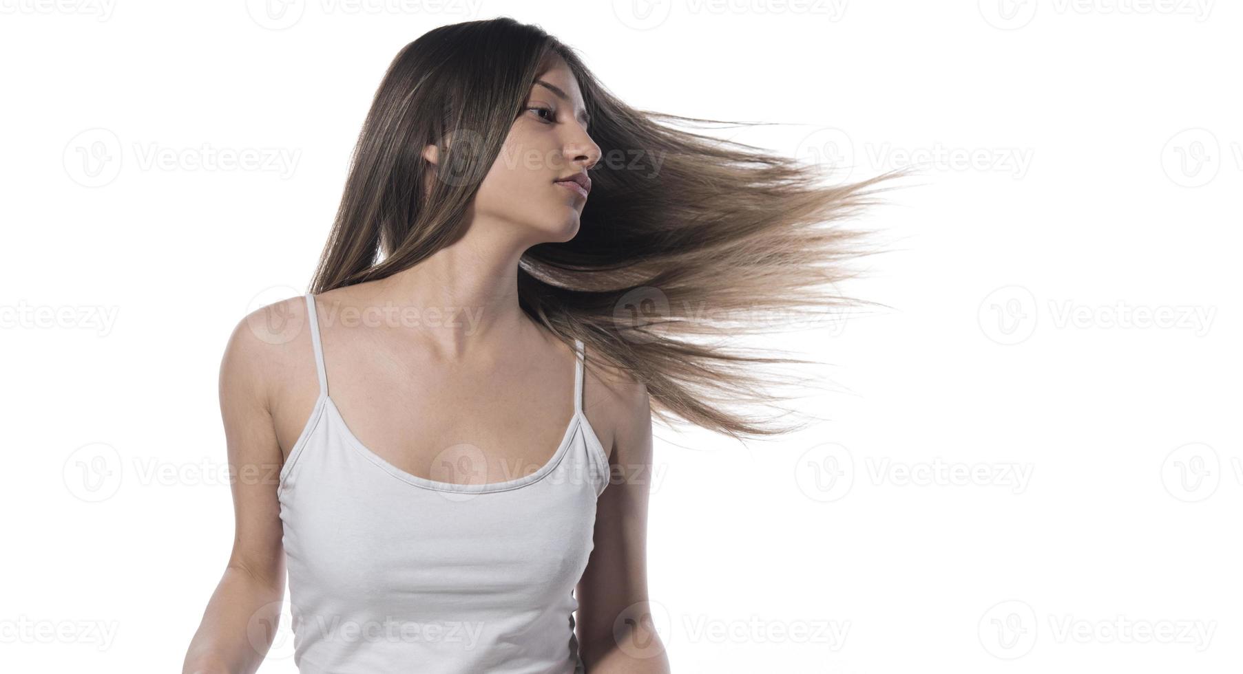 Portrait of the young woman with flying hair. isolated photo