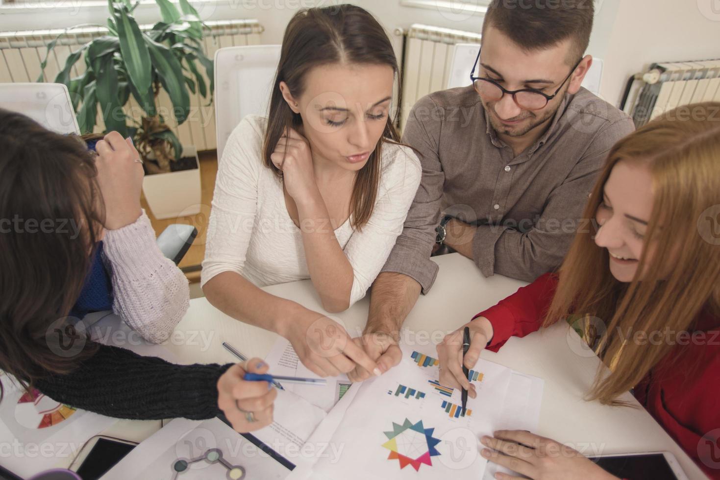 business woman explaining business matters to her team in a boardroom photo