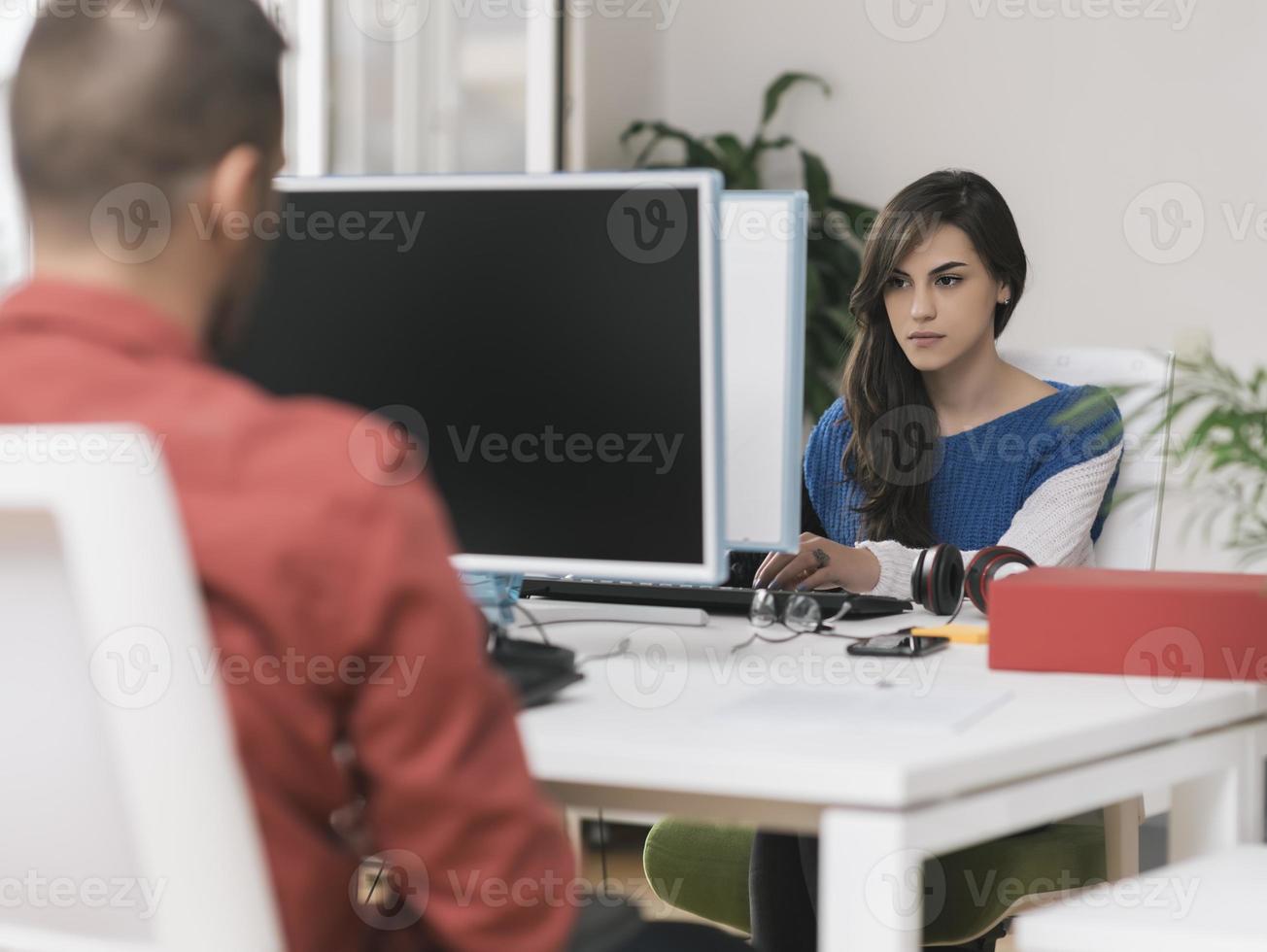 Freelance work. Two partnerships developing programming and coding technologies working on laptop and analyzing together. photo