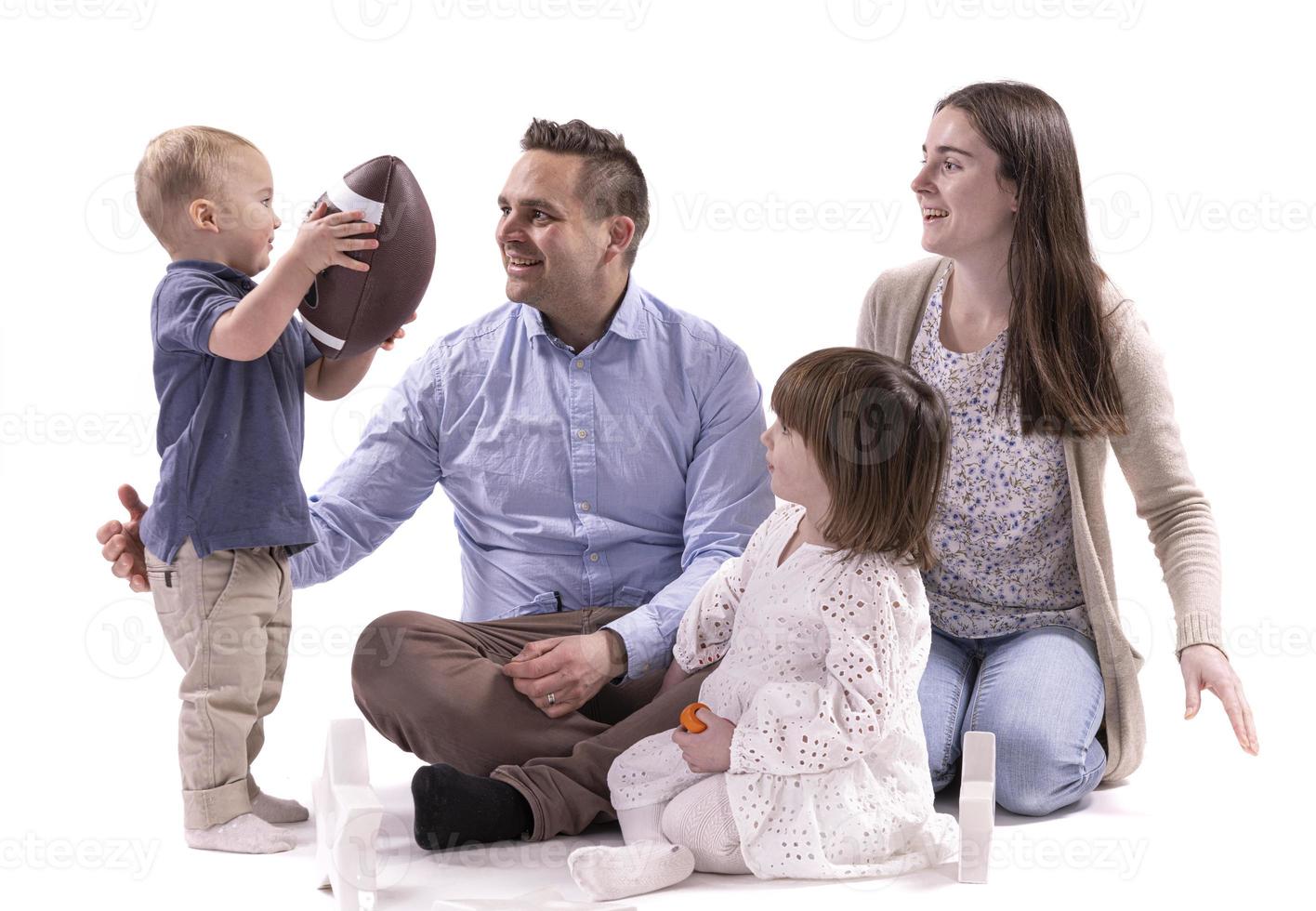 Happy to be a family. Happy family of four bonding to each other and smiling photo