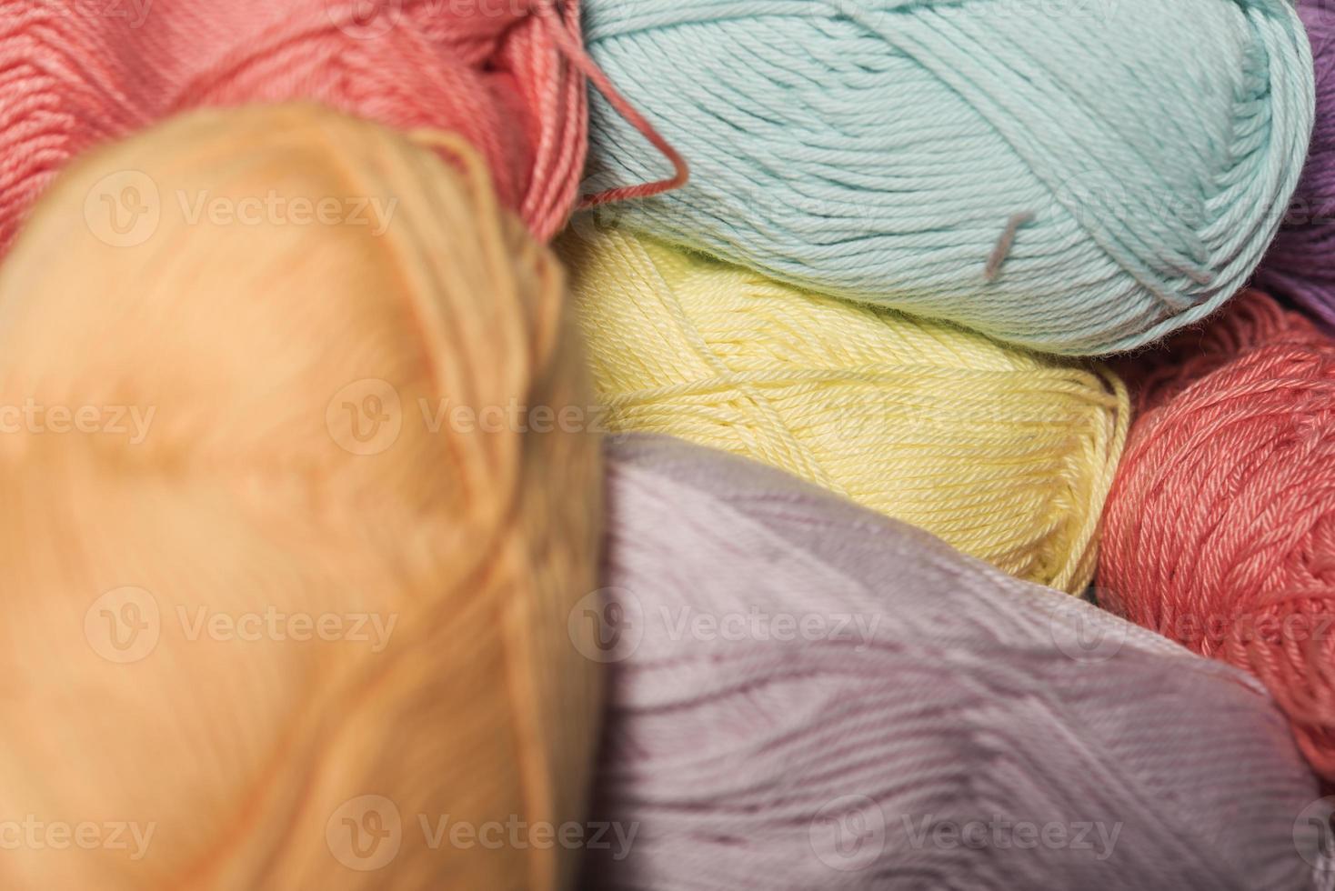 Colorful balls of wool on wooden table. Variety of yarn balls, view from above. photo