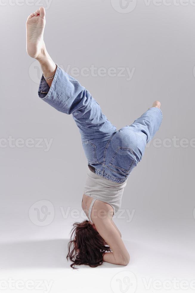 retrato de una hermosa joven con un cuerpo atlético y flexible haciendo estiramientos de piernas. aislado foto