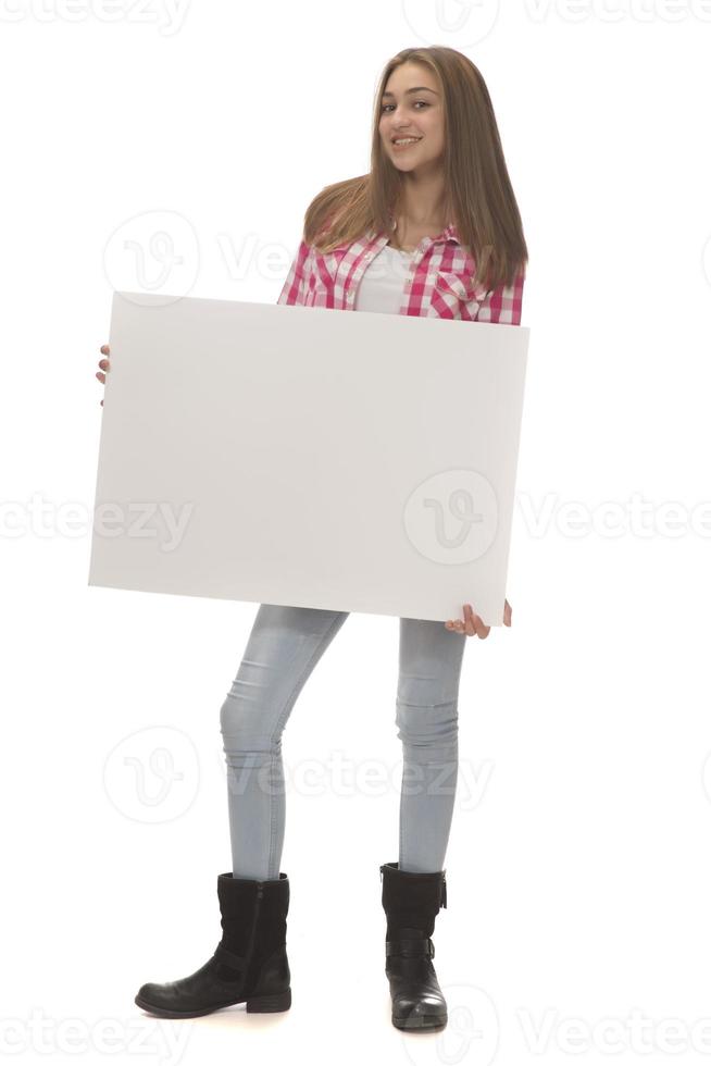 young smiling woman holding a blank sheet of paper for advertising photo