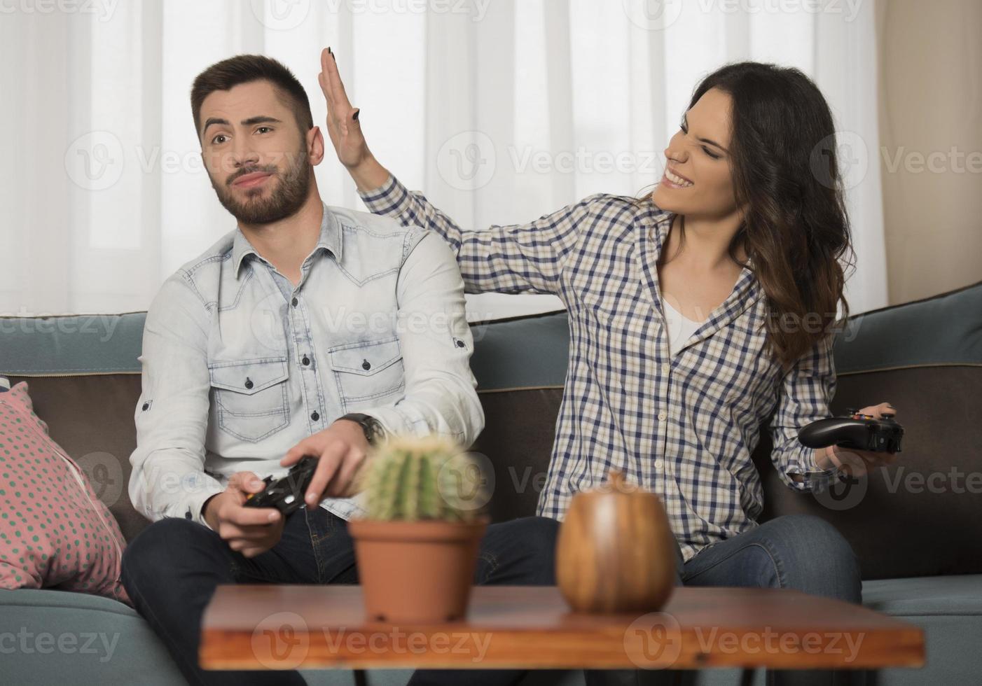 happy smiling couple playing video games at home. photo