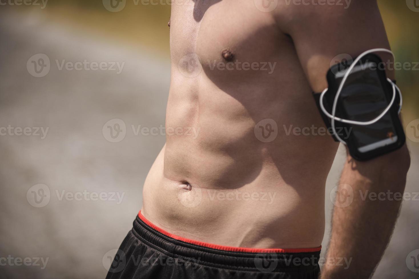 Athletic young man stretching after run in the nature. sport concept photo