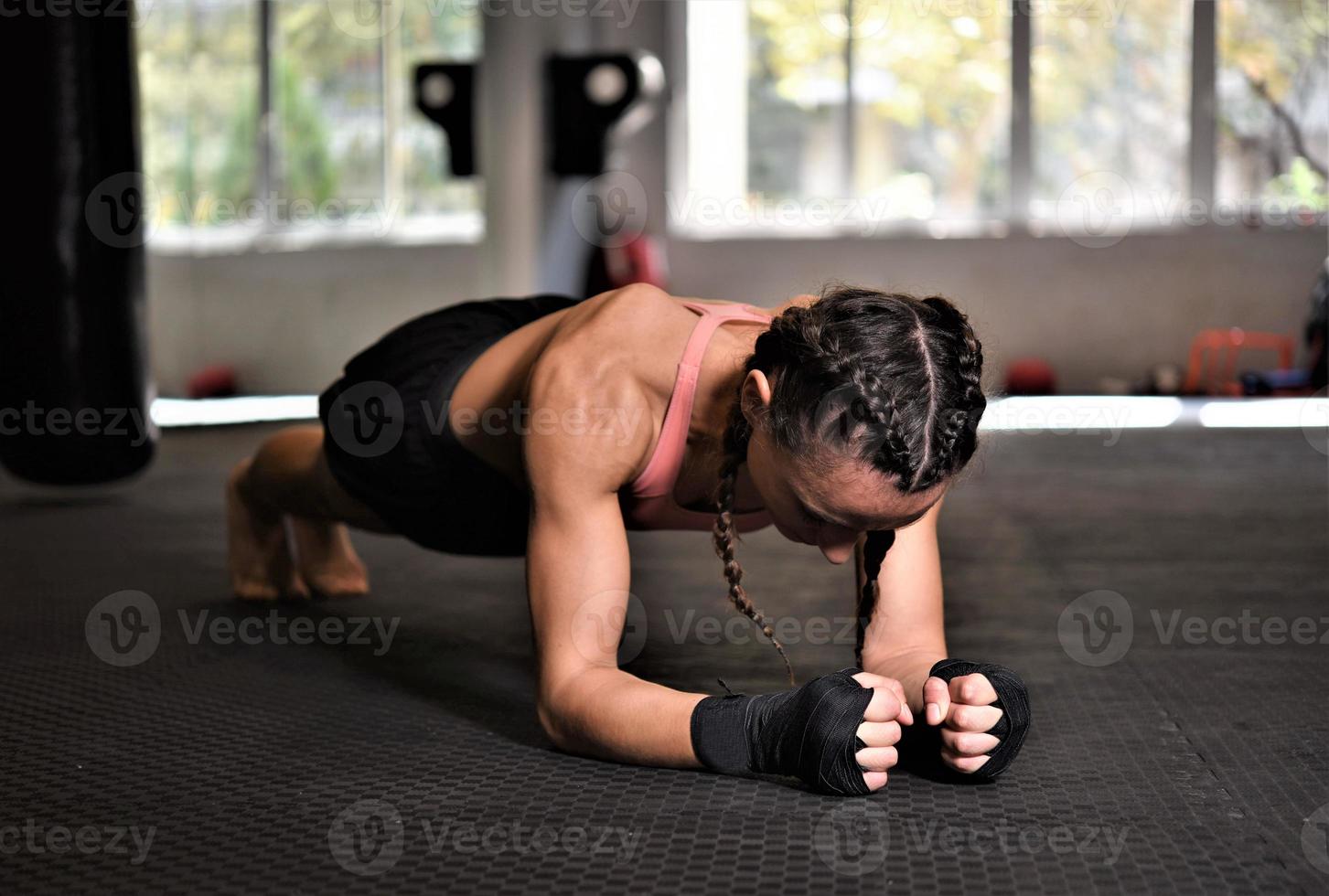 Woman on boxing training doing push ups photo