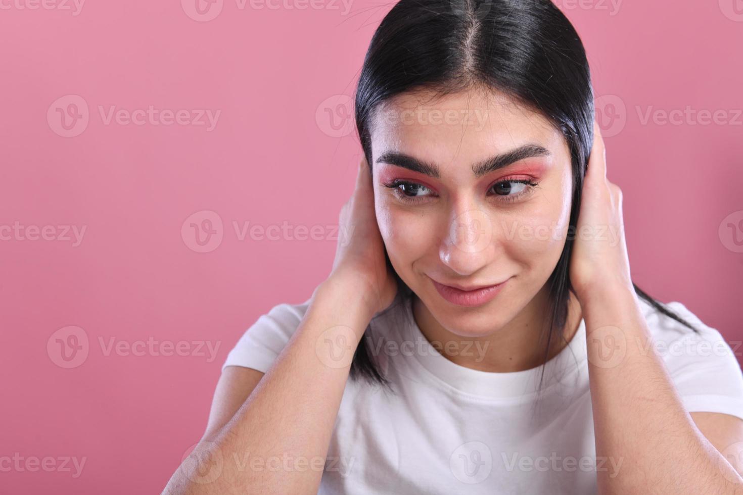 tudio shot of a young beautiful woman with long gorgeous hair posing and holding hair photo