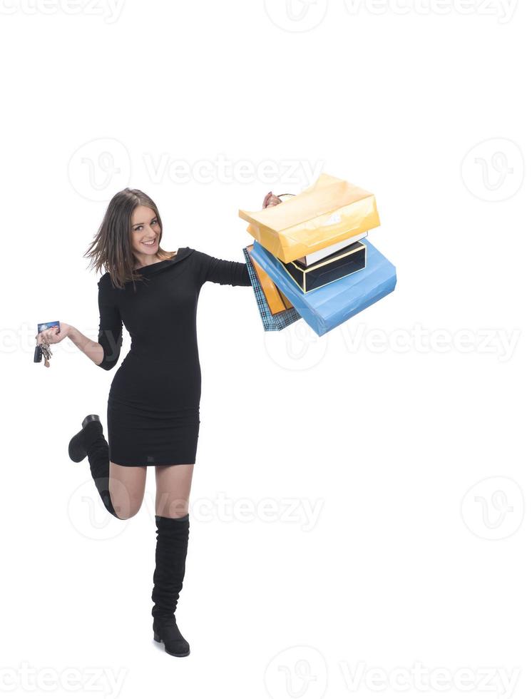 Happy woman full body portrait with shopping bag on isolated studio background. photo