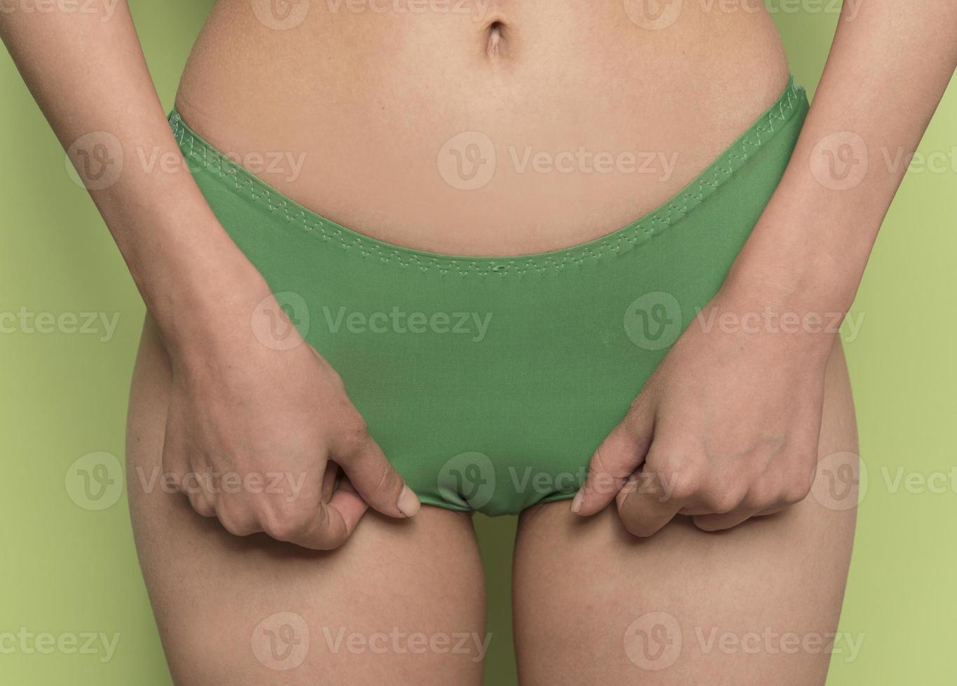 close-up view of nice unrecognized fit lady posing  putting panties on photo