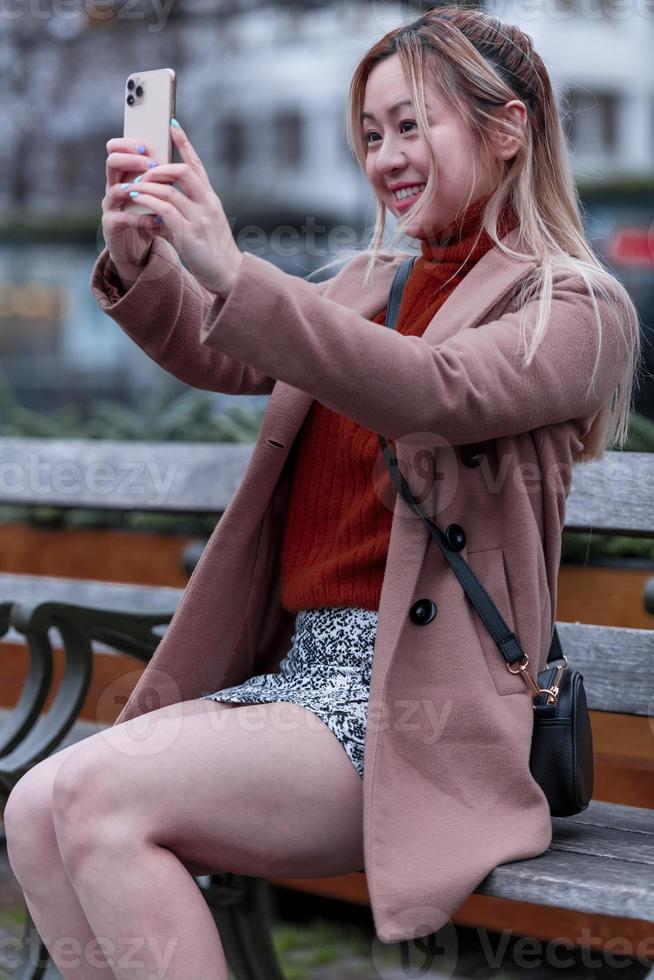 Outdoor portrait of young Asian beautiful fashionable happy woman. Model posing outdoor. photo