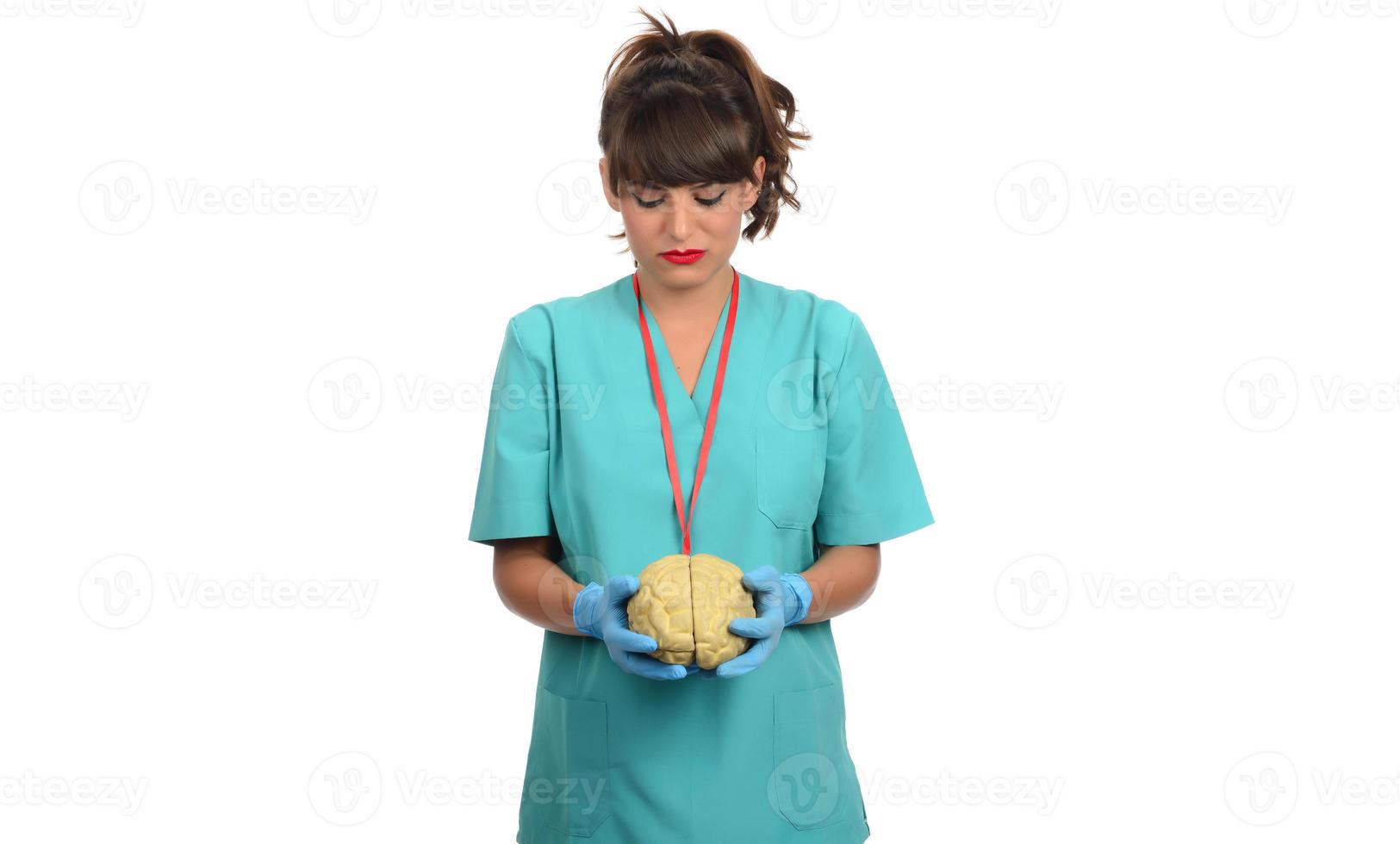 Female doctor holding a human brain model against white background photo