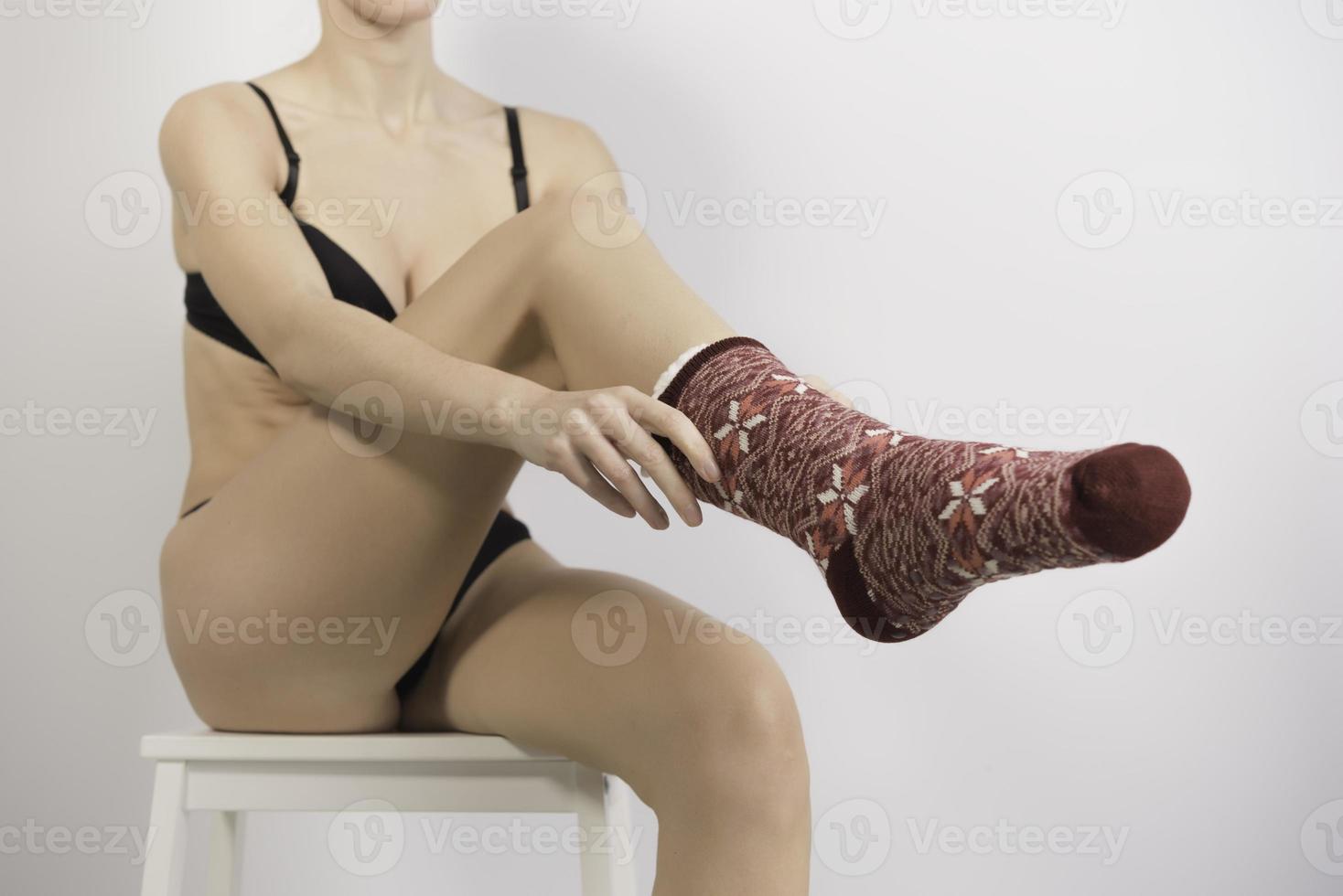Feet in woolen socks by the Christmas fireplace. photo
