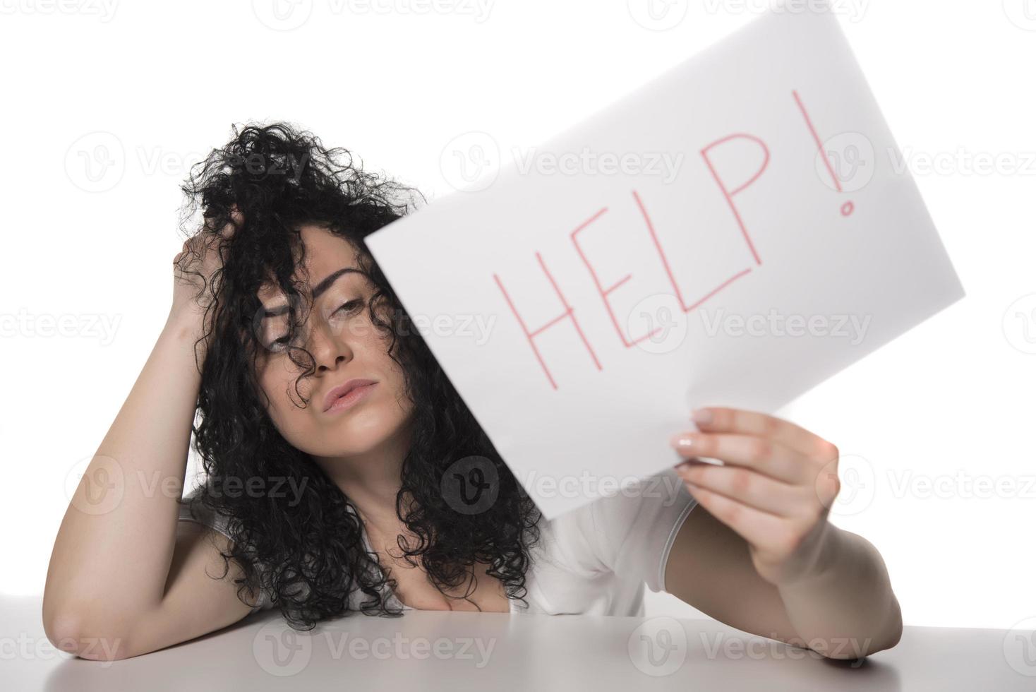 young attractive frustrated and tired businesswoman holding help sign message overworked at office computer, exhausted, sad under pressure and stress isolated on white photo