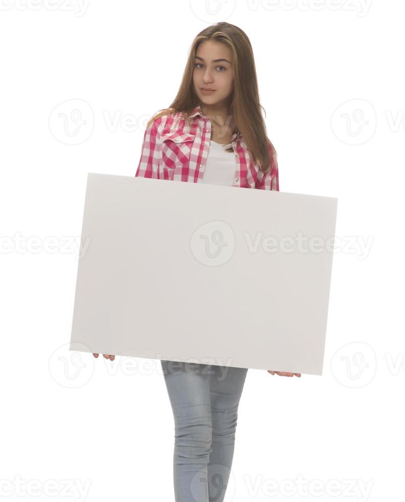 young smiling woman holding a blank sheet of paper for advertising photo