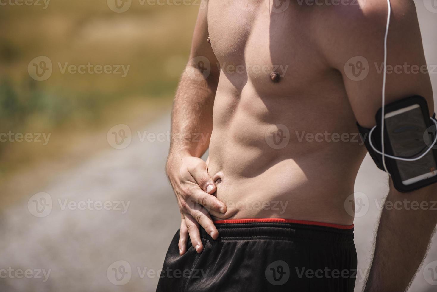Athletic young man stretching after run in the nature. sport concept photo