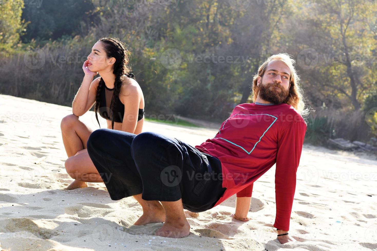 friends relaxing and talking on the beach photo
