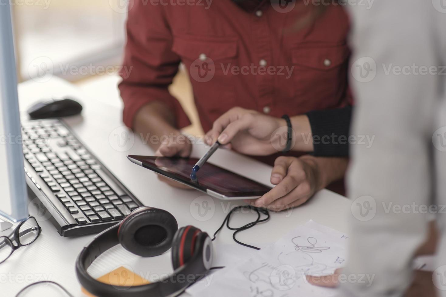 Two partnerships developing programming and coding technologies working on laptop and analyzing together. photo