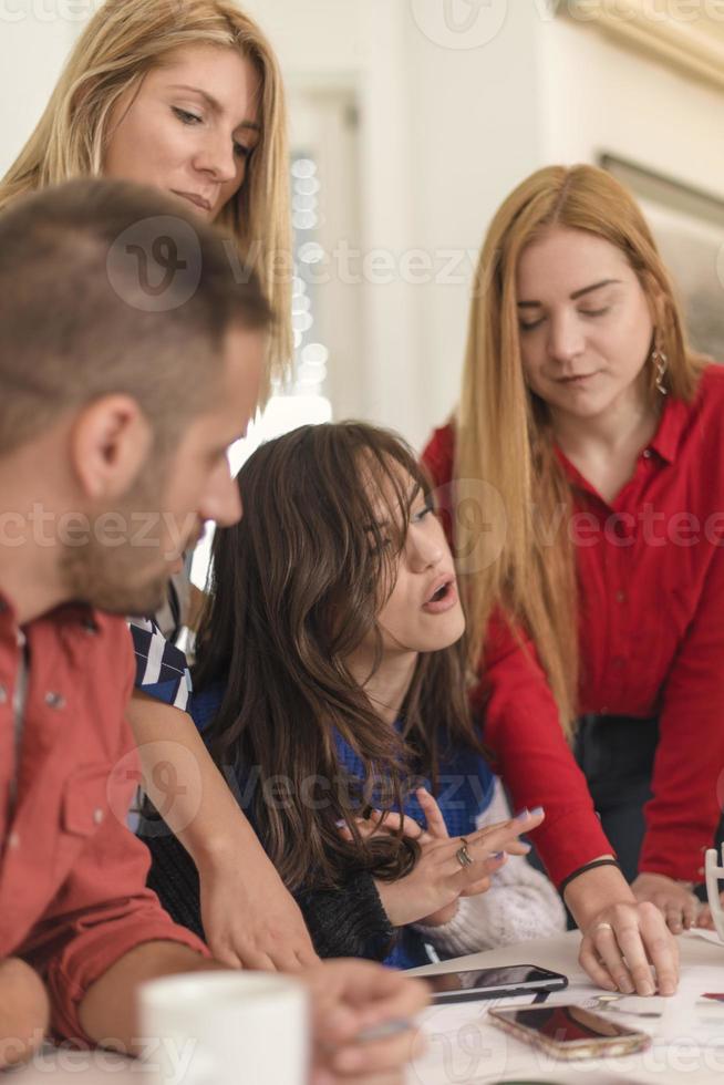 business woman explaining business matters to her team in a boardroom photo
