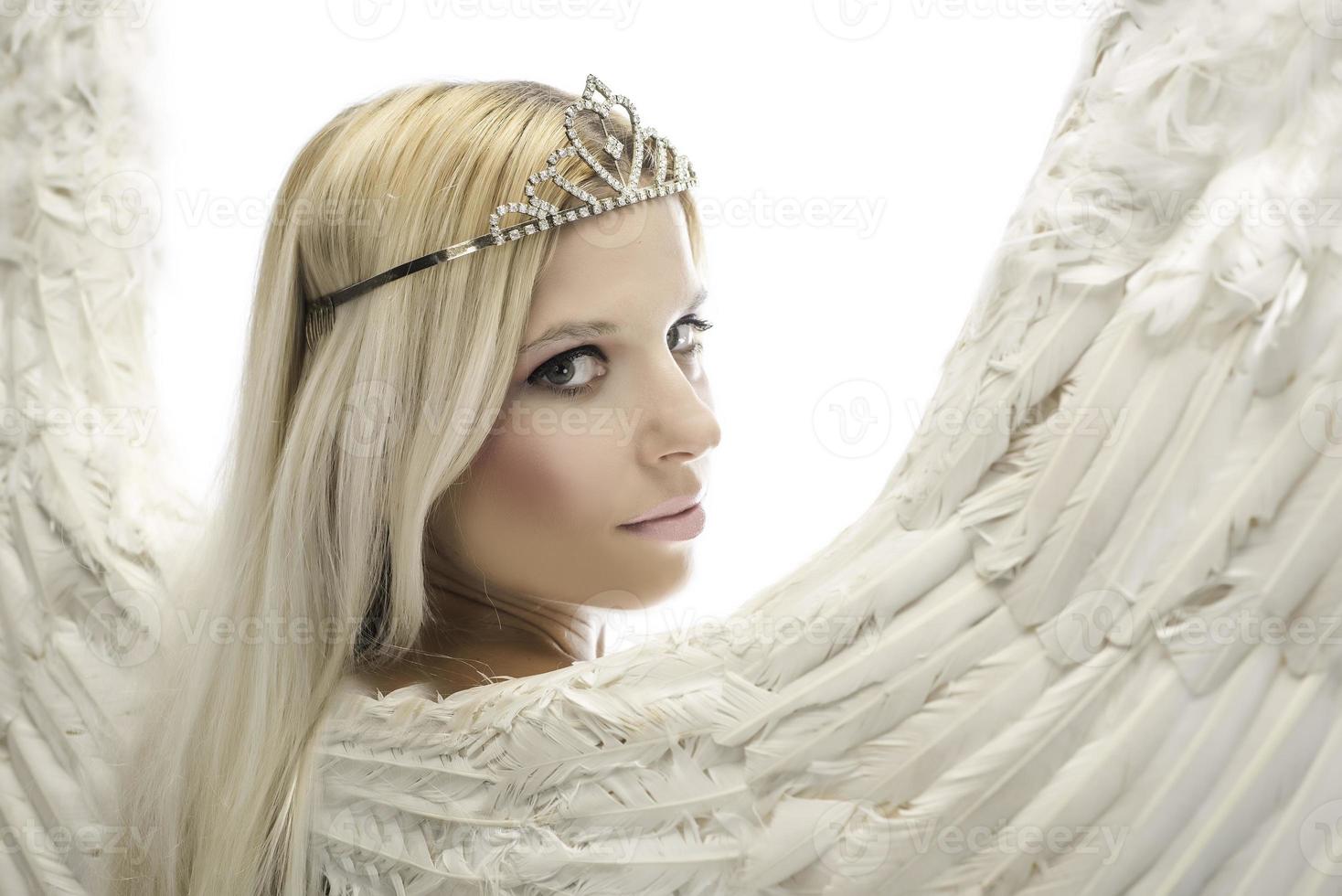 Portrait of beautiful blonde woman with angel's wings. Angel with long curly hair photo