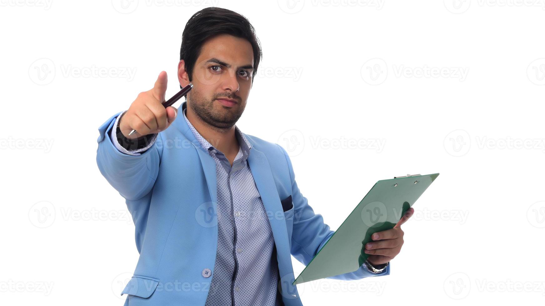 Arab businessman holding paperwork on clipboard and pointing with his finger. isolated on white photo