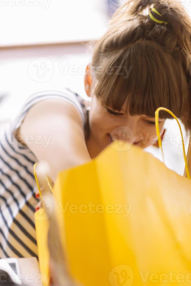 Portrait of cheerful Caucasian young couple man and woman holding many paper bags after shopping while walking and talking on street. Happy family couple with packages outdoor. Buying concept photo