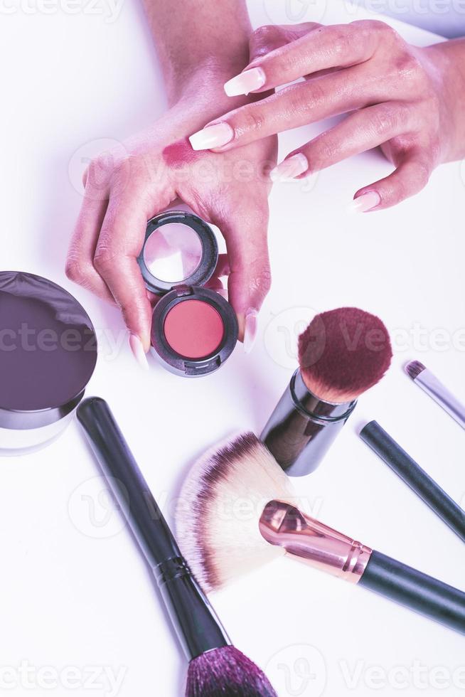 Decorative cosmetics and makeup brushes photo