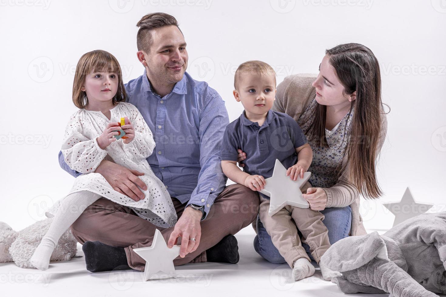 Happy to be a family. Happy family of four bonding to each other and smiling photo