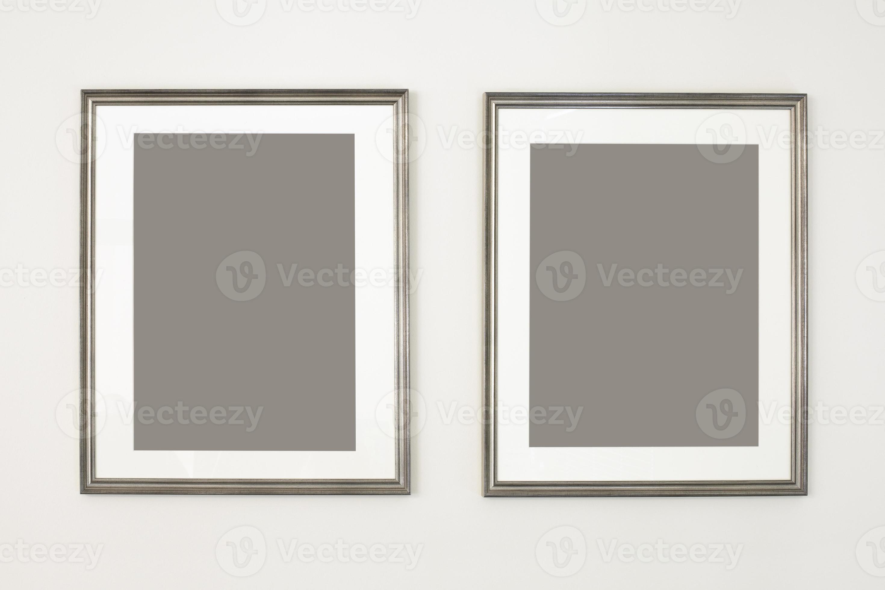 Two vertical frames, poster mock up. Empty silver picture frames