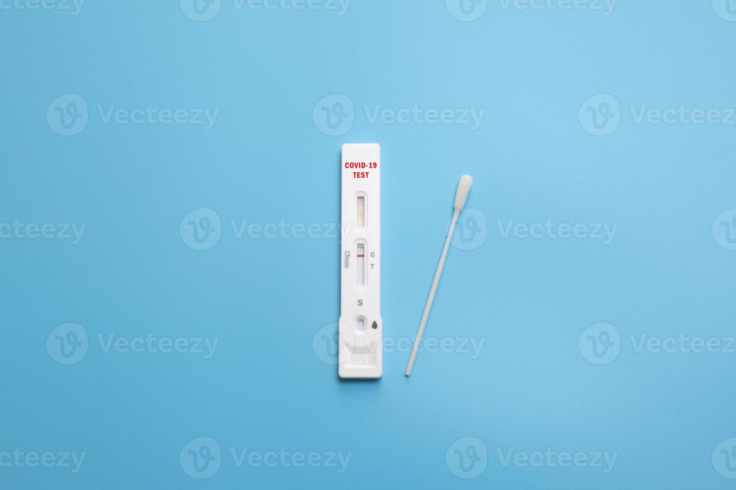 Rapid Coronavirus test on the blue background. Negative test result by using rapid test device for COVID-19. photo