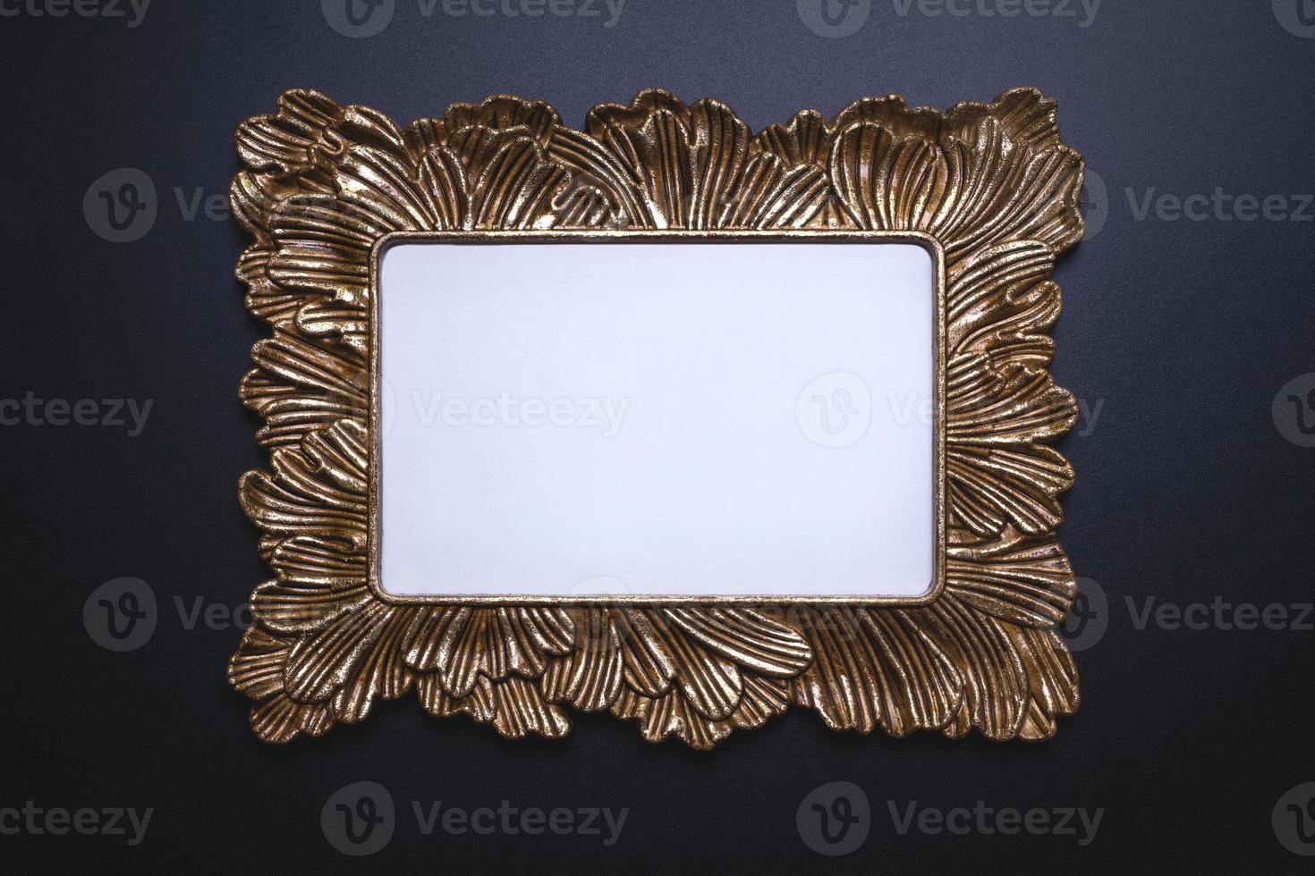 Elegant background, template for text, logo or picture. Golden decorative picture frame on the black background. Free space, copy space. photo