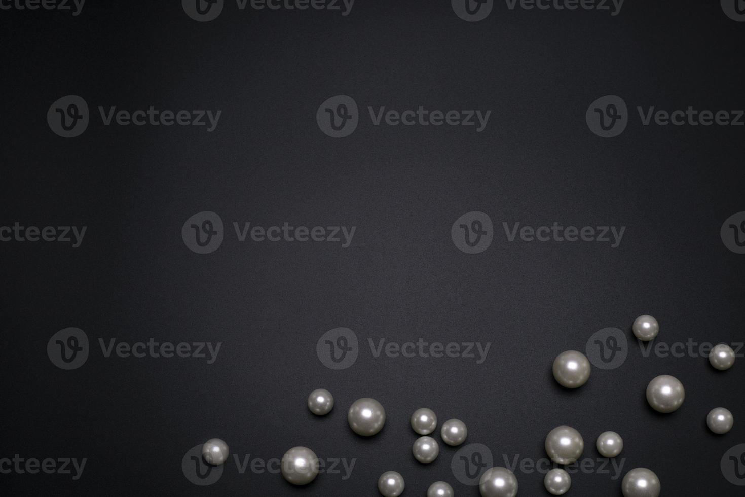 Pearls on the black background, with free space for text. photo