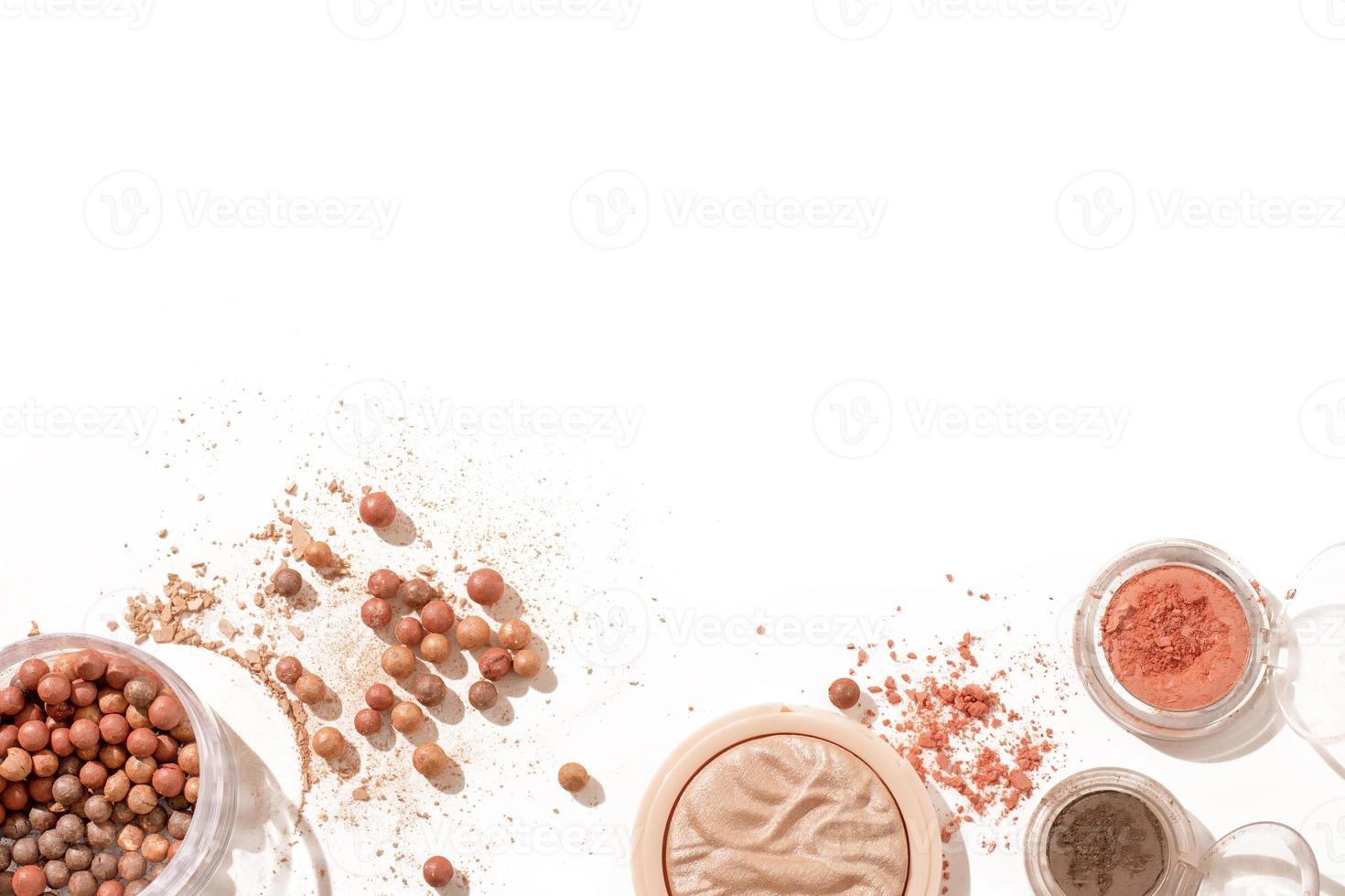 Crushed eyeshadow and face powder isolated on white background. Makeup composition with copy space, free space for text. photo