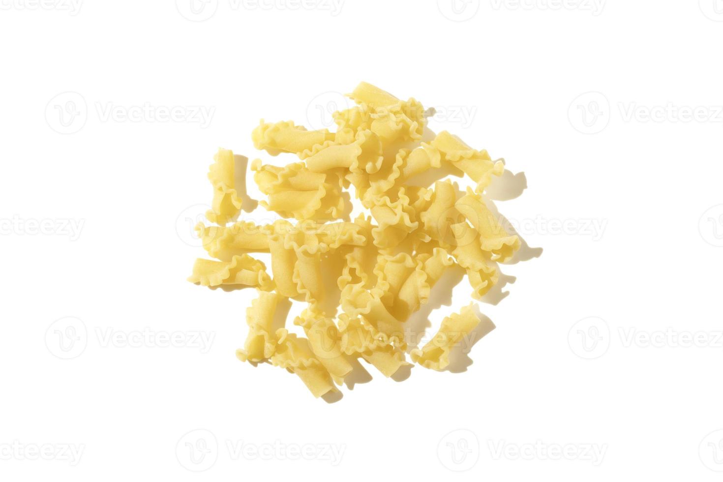 Creste di gallo pasta isolated on white background. Heap of uncooked dried pasta, traditional Italian cuisine. Top view. photo