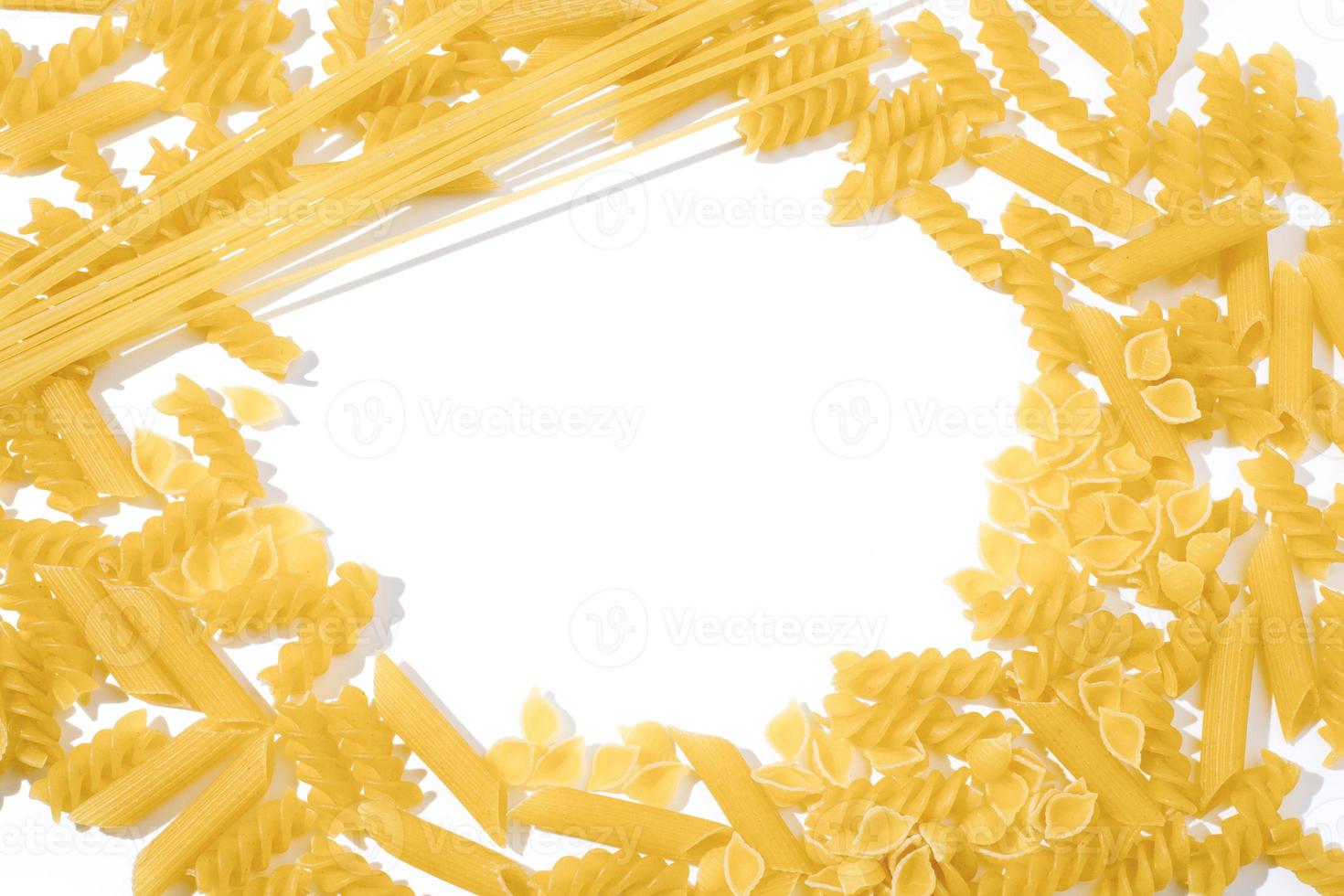 Various raw pasta on white background. Traditional Italian cuisine. Top view. Copy space, free space. photo