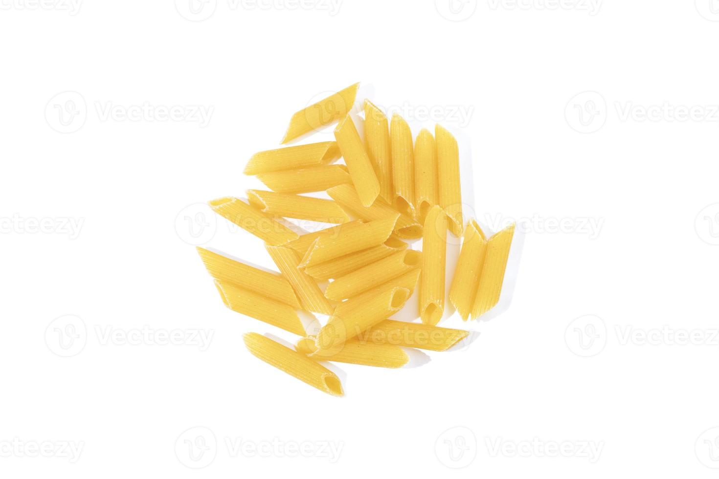 Penne pasta isolated on white background. Heap of uncooked dried penne, traditional Italian cuisine. Top view. photo