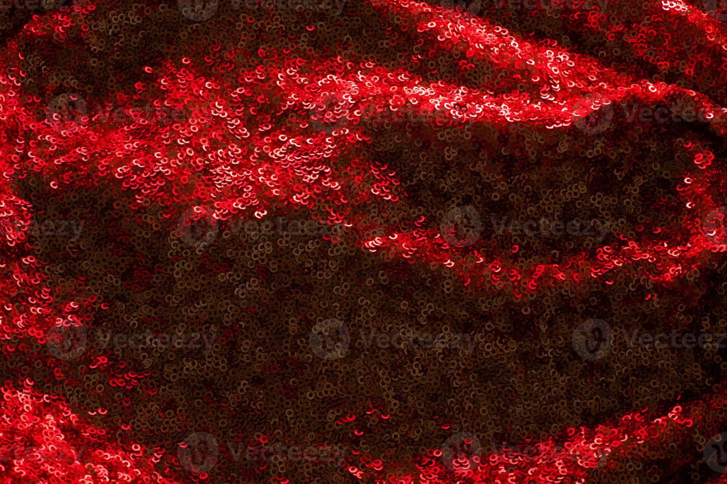 Shiny and glittering red fabric with sequins. Abstract background. Events, celebrations, Christmas, New Year. Trendy backdrop. photo