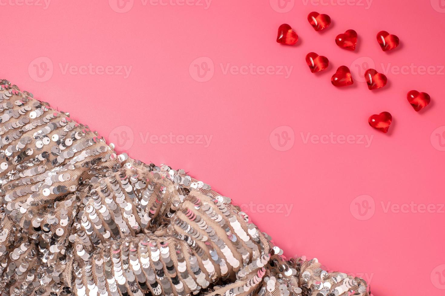 Pink Valentine's Day background with hearts and shiny, glittering fabric with sequins. Free space for text, copy space. Postcard, greeting card design. Love, celebration concept. photo